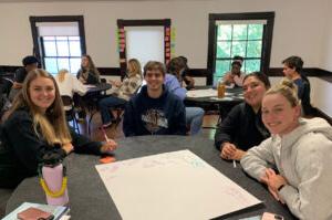 Converse Sullivan Fellows write ideas on a whiteboard.